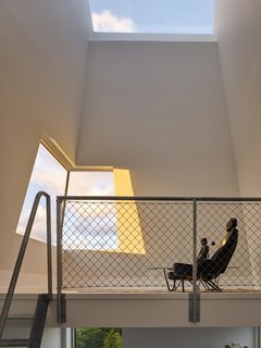 Chairs made from the seats of a Ferrari BB 512 face the tower’s large window, which overlooks the sea