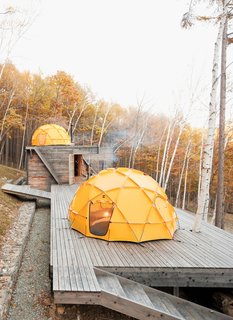 A Platform for Living - Photo 1 of 28 - One North Face tent sits atop a deck; another caps the main building, which contains a kitchen and dining area.