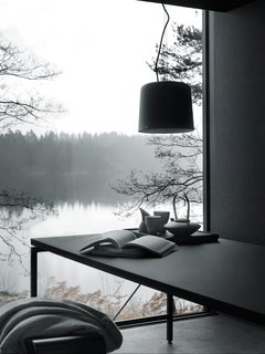 Vipp's prefab Shelter requires a delivery time of six months and costs $585,000. Pricing includes interior fittings, all by Vipp, including bathroom vanity, lighting, leather daybed, kitchen island, dining table (pictured), bedding, storage, and even kitchen utensils.