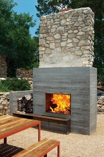 The outdoor fireplace is one of the few remnants of the original structure.