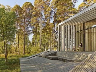 The wood on the exterior has been treated with linseed oil or painted with tar. Seats built directly into the pavilion’s frame allow the family to relax and enjoy the surrounding woodlands without the need for additional furniture.