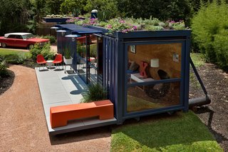 Jon Ahrens of Madrone Landscaping, who layed out the plantings around the container, implemented a green roof on a drip watering system. The cantilevered overhang at rear is planted with cacti.