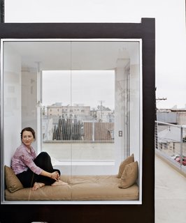 Irish-born actress Cornelia Hayes-O’Herlihy gazes across the Venetian roofscape. Her cozy glass enclosure rests atop the new home designed by her husband.