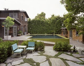 Across the path is the resident's favorite spot from which to take in the aquatic tableau: a rock garden and sitting area created by landscape designer Tory Polone. Chairs rest near the a hidden grade-level gas fire pit—an on-demand campfire.
