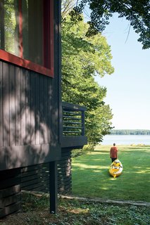 Campbells' Coup - Photo 12 of 12 - The cottage sits on an acre of mature trees, with a sloping lawn stretching to the pebbly shore of the inland lake. The Campbells regularly drag their kayaks down to the water’s edge and set off toward the deeper waters of Lake Michigan.