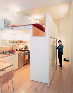 Raising the bed above floor level, architect Kyu Sung Woo converted this tiny studio into an open and comfortable home for Wonbo Woo. 