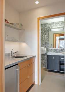 The kitchenette countertops are made from recycled concrete. The bathroom tile is by Pental.