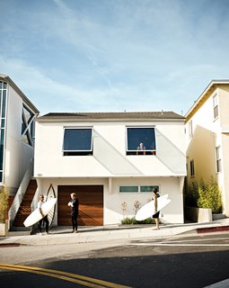Joined by architect Michael Lee and friend Gus McConnell, Jacobson shouts up to Dukes that they’re headed out for an impromptu surf session.