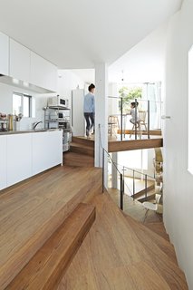 The top of the house is dedicated to a dining area and a kitchen outfitted with steel-topped cabinets from Sanwa Company. 