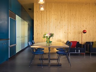 Eames Wire Chairs, cushioned with custom pads, surround a dining table designed by Bolander.