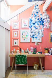 This vibrant room features Tango-painted walls by Delux, artwork by Rachel Castle and Beci Orpin, handmade beaded chandeliers by Emily Green, and a kicky pineapple lamp by Down to the Woods.