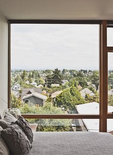The third-floor master bedroom boasts sweeping views of Seattle.