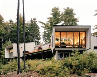 Viewed from a good distance down the slope running to the Union River, the Maison Amtrak is clearly oriented toward the river. The deck is sheltered from the neighbors’ view by Cohen’s bedroom to the right and the living room at left.