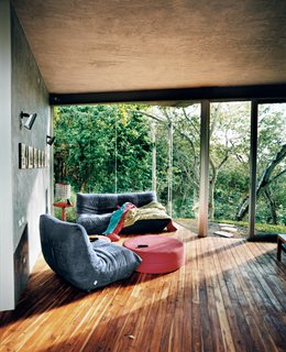 Welcome to the Jungle - Photo 6 of 8 - The family room contains furniture reminiscent of Ligne Roset’s Togo collection and a CH 07 egg-carton lamp by Salvadoran designer Eugenio Menjívar.