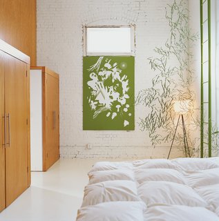 A Minneapolis Building That Has Lived Multiple Lives Is Revitalized by a Coffeehouse Owner - Photo 4 of 10 - The bedroom is decorated minimally by another Vogt screenprint, and a strand of green Algue.