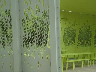 A leafy pattern, carved by a water-jet cutter, allows views through the sides—an aesthetic touch that doubles as a nod to security in the park, where crime has been an issue. Photo by Architexas.