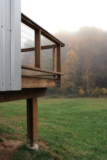 An off-the-shelf post-and-beam system is used as foundation for the porches. Welded wire mesh is used for the guardrail. Image courtesy Chad Everhart Architect.