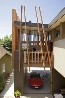 The new master bedroom is directly above the new garage. The beams that support the upper level cant out from the masonry walls of the garage.