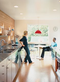 The Deans’ new kitchen is long and narrow, punctuated by the small windows that dot the façade and one large light-giving window at the end.