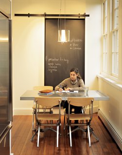 Designer Jeff Sand’s Universal Chairs combine his love for classic French cafe chairs with an appreciation for "the beautiful metal casings on an old Moto Guzzi." Sand Studios also designed the dining table and pendant lamp.