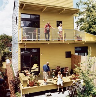The living room of the tower transitions to a sizable balcony overlooking a private rear courtyard. As Gatzke notes, the design of the house emphasizes flexibility and <br><br>evolution of uses for the three distinct spaces: "The ground-floor ‘bar’ unit could be <br><br>internally connected to the studio apartment and upper floors, allowing it to be rented or combined as a larger single unit."