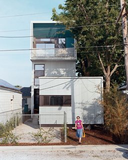 Julie Charvat of Bild Design exits the Lowerline House. Raised three feet off the ground—rather than slab on grade—the house is well equipped to battle any incoming flood waters.
