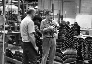 Charles Eames (right) visiting the Herman Miller factory, where the Eames Lounge and Ottoman has been produced since its 1956 debut.