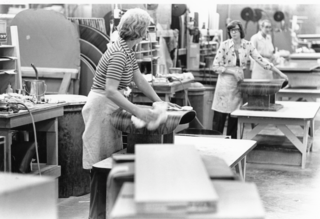 Employees at the Herman Miller factory polish the molded plywood shells in the seventies.