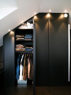 6 Ways to Declutter and Free Up Space in Your Bedroom - Photo 1 of 8 - This apartment's built-in closets are deep and have mirrors on one side. Spotlights set flush overhead provide light and also allow the maximum amount of storage, all the way to the ceiling. 