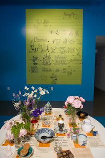 Charles created this rebus for his daughter, Lucia, when she was a child. "Some people want a key for it; some don’t," says Sussman. Ray’s table was curated by artist Tina Beebe, who worked closely with Ray in the Eames Office and decorated the surface with the flowers and objects Ray favored.
