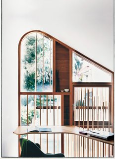 The delicate wooden dowels, used both on the exterior facade and the mezzanine level balustrade, are nods to the bamboo fences traditionally found in tea gardens.