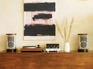 Pearson and Trent designed the sideboard just tall enough so that their young children, Delphine and Chantal, couldn’t reach the vintage stereo. Above it is a painting by Los Angeles artist Jon Pestoni.