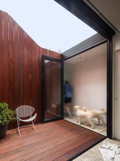 In the courtyard, the fence line climbs upward, drawing the eyes to the clouds.
