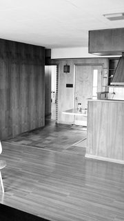 The kitchen was formerly closed off and now flows into the living room post renovation.