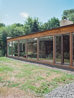 He added floor-to-ceiling windows by Andersen, which allow low winter sunlight to warm the interior in colder months.
