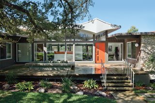 The roofline, set on top of glass clerestories on a transparent central volume, begat the building’s local nickname: Butterfly House.