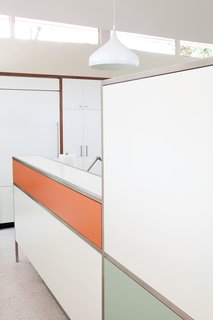 Builder Jason Miars fabricated the walnut-paneled walls and kitchen cabinetry, which is accented by stainless-steel Linnea drawer pulls.