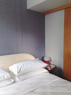A detail of the Maya Romonoff-designed felt wallcovering, a custom modification of an existing pattern that sports a vertical red line motif.