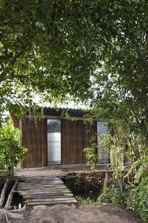 The key to the home's relative affordability is the selection of materials. A prefabricated frame is covered in natural materials, such as Nipa palm, that can be easily replaced and maintained, while seamlessly blending in with the surrounding environment.