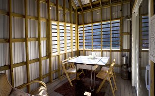 The Everharts added two porches to the form of the original farmhouse. This one is for dining. Image courtesy Chad Everhart Architect.