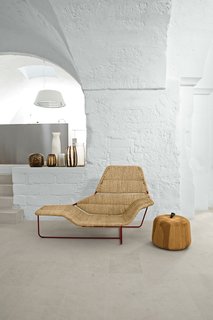 Modern Meets Ancient in a Renovated Italian Vacation Home - Photo 2 of 8 - Serafini and Palomba’s vacation home is a cavernous showcase for their own designs. In the living room, they created a one-off version of their Lama chaise longue, originally designed for Zanotta. The Zen Apple side table, also theirs, is from the Sen Line Collection by Exteta. The vases are by Guaxs.