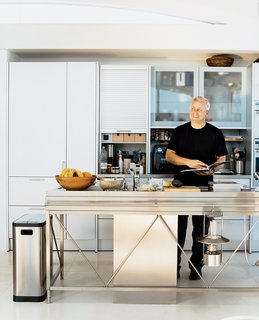 Opening onto the open-plan living and dining rooms, the aluminum Bulthaup System 20 kitchen with its nine-foot-long stainless steel island and Miele appliances has become a focal point of the house. Pressed in one seamless sheet of steel, the island, Picard says with the obvious pride of a satisfied customer, "is an amazing piece of engineering."