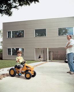 Leroy tools around on his mini turbo tractor while munching on a gigantic cookie; his parents look on with envy.