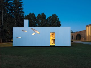 Seen from the outside, angular slits offer tantalizing glimpses of the home's interior.