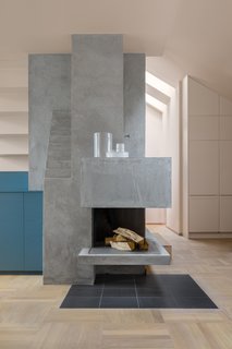 To inform the color palette for this interior renovation in Stockholm, NOTE Design Studio began with three inspirational images. The sculptural fireplace, covered in plaster, contrasts with oak parquet floors.
