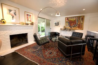 The elder Popp bought the Le Corbusier chairs in the ’80s and the Arco Flos lamp in the ’70s; the Philippe Starck barstools were purchased recently for the apartment. The antique rugs are from Ronald Popp’s collection, and the art is by mostly Bay Area artists. To help control costs, Popp worked with much of the existing 1950s building’s elements, such as the brick fireplace, giving it a coat of white paint "to provide a better background for the art." Just off the living room, accessed through a floor-to-ceiling glass door, is a garden for Popp’s father.