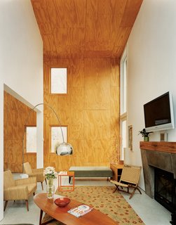 Gaffney House Dining Room - Photo 6 of 10 - The double-height living area features unfinished plywood cladding.