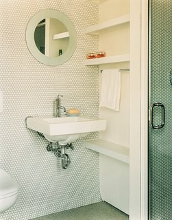 Gaffney House Dining Room - Photo 7 of 10 - In the guest bathroom, penny tiles were chosen "because they’re incredibly economical, utilitarian, and we liked their kitschy feel," explains Gaffney.