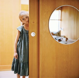 Long Island Found - Photo 9 of 12 - Eight-year-old Emily peeks out from a sliding panel door with matte marine hardware that will age gracefully in the salty air.
