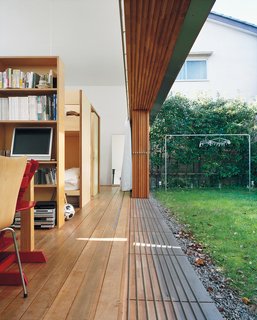 The magic wall-disappearing act is accomplished by means of sliding glass panels, which the family tends to leave open almost year-round. Miharu Higashibata says she feels the new home has strengthened the family bond through shared activities like cooking and gardening.